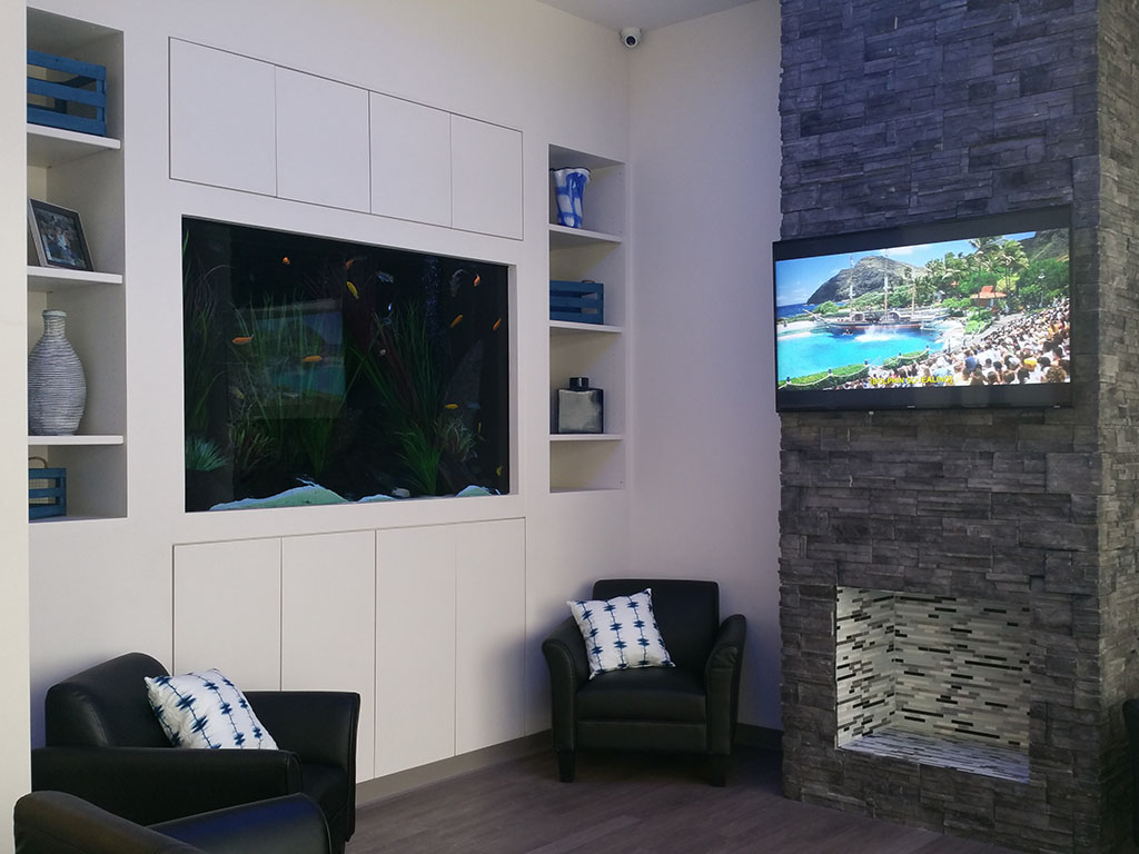 The Villa Dental waiting area with its fireplace and aquarium